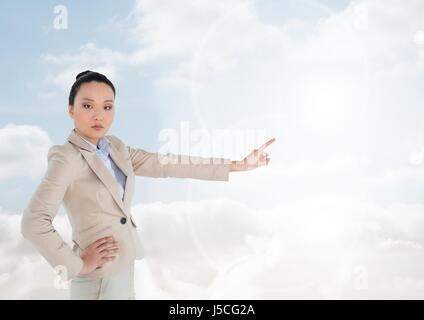 Digital composite of Woman pointing in  air of bright sky Stock Photo