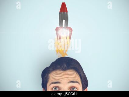 Digital composite of Portrait of man with rocket over head Stock Photo