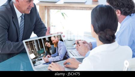 Digital composite of Business people video conferencing with colleagues on laptop Stock Photo