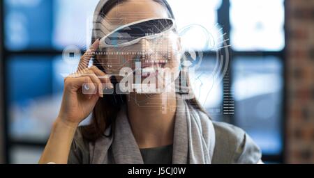 Digital composite of Digitally generated image of various icons with businesswoman using VR glasses in office Stock Photo