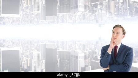 Digital composite of Thoughtful businessman with upside down city in background Stock Photo