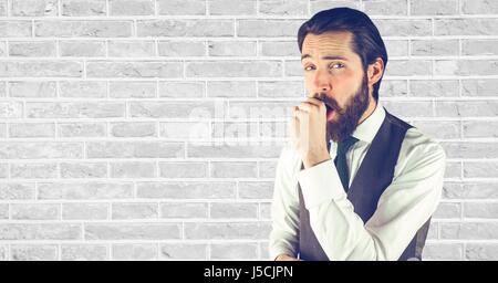 Digital composite of Hipster coughing against wall Stock Photo