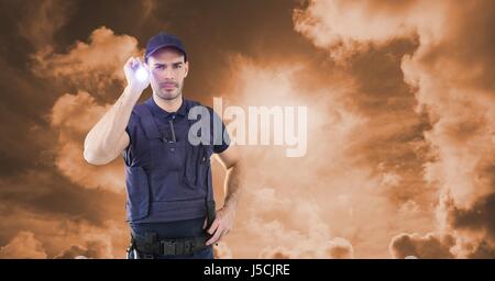 Digital composite of Security guard holding flashlight against sky during sunset Stock Photo