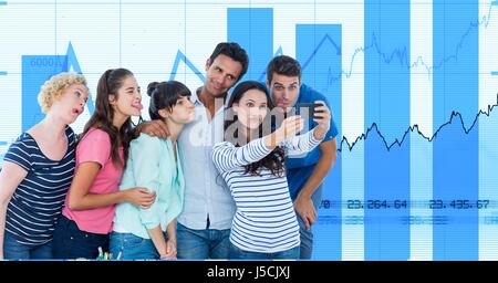 Digital composite of Casual business people taking selfie on smart phone against graphs Stock Photo