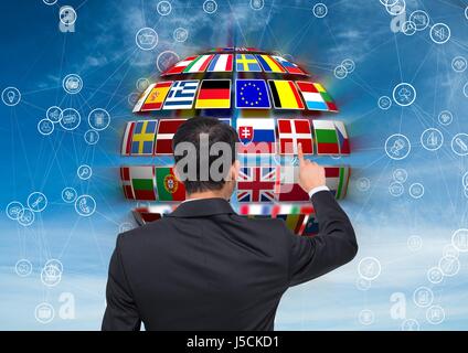 Digital composite of panel with flags on a ball and business man doing something on it Stock Photo