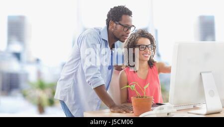 Digital composite of Business people using computer in office Stock Photo