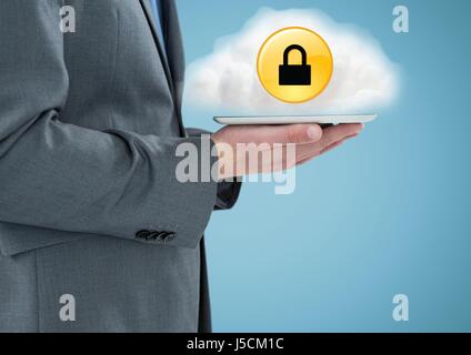 Digital composite of Business man mid section with tablet and cloud with yellow lock icon Stock Photo