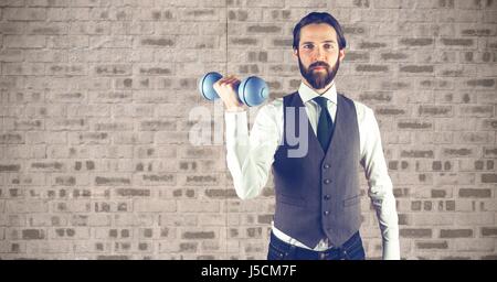 Digital composite of Hipster lifting dumbbells against wall Stock Photo