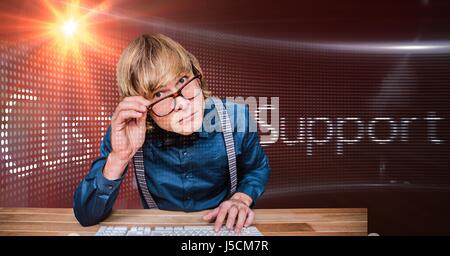 Digital composite of Male hacker wearing eyeglasses against screen Stock Photo