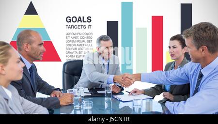 Digital composite of Business people shaking hands against graphs Stock Photo