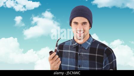 Digital composite of Smiling hipster holding smoking pipe against sky Stock Photo