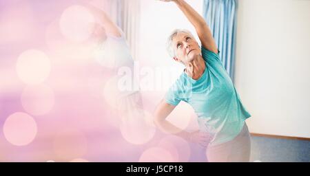 Digital composite of Senior woman exercising with bokeh in foreground Stock Photo