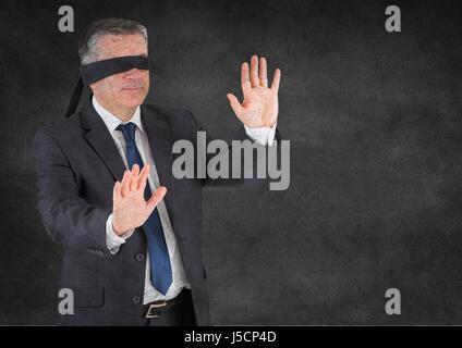 Digital composite of Business man blindfolded with grunge overlay against grey wall Stock Photo