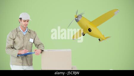Digital composite of Delivery man writing on clipboard by parcel against 3d airplane Stock Photo