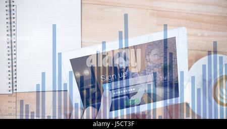 Digital composite of Hand signing in digital tablet with overlay Stock Photo