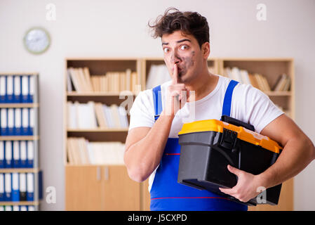 Funny Man doing electrical repairs at home Stock Photo