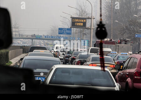 BEIJING, CHINA-CIRCA MARCH 2014:-Rush hour on the inner ring road the traffic crawls through the smog. Stock Photo