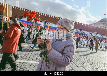 MOSCOW, RUSSIA - MAY 9, 2017: “Immortal regiment” procession in Victory Day- thousands of people marching along toward the Red Square with flags Stock Photo