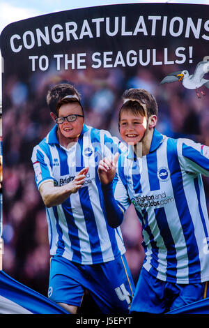 Young Football Fans Of Brighton and Hove Albion Pose For Photographs At A Face In The Hole Board, Brighton, Sussex, UK Stock Photo