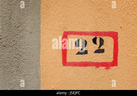 number 22 painted on house wall Stock Photo