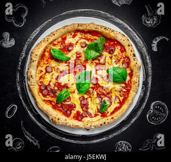 tasty Italian pizza with basil Stock Photo