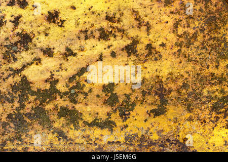 Rusty iron metal surface with yellow paint. Texture and background Stock Photo