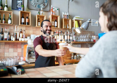 man or waiter serving customer in coffee shop Stock Photo