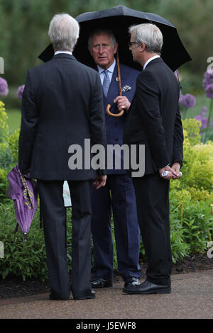 The Prince of Wales stands in front of allium flowers planted in the Great Broad Walk Borders at the Royal Botanic Gardens, at Kew, Richmond, Surrey. Stock Photo