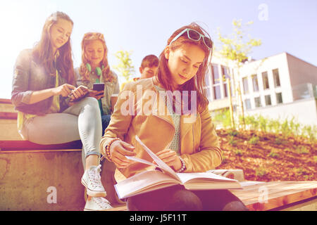 high school student girl reading book outdoors Stock Photo