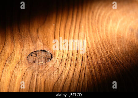 Nice wooden background with knot under beam of light Stock Photo