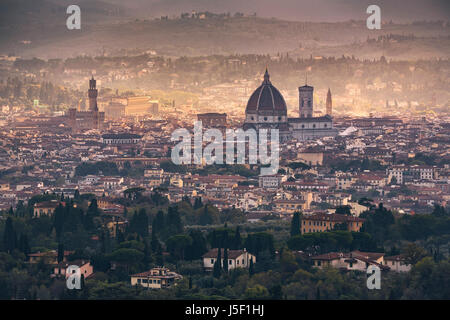 Florence or Firenze aerial foggy cityscape. Panorama view from Fiesole hill. Palazzo Vecchio and Duomo Cathedral. Tuscany, Italy Stock Photo