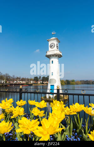 Yellow Tulips blooming in front of the Robert Scott Memorial Lighthouse at Roath Park Lake, Cardiff, Wales, UK. Stock Photo