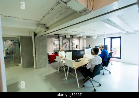 Young programmers sit and work in a modern office Stock Photo