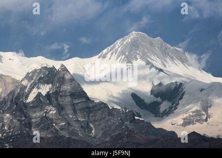 Dramatic snow capped Himalayan peak of Mount Annapurna one of the many peaks making up the Annapurna Massif in the Himalaya mountain range of Nepal Stock Photo
