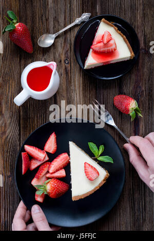 Strawberry cheesecake on black plate table top view Stock Photo