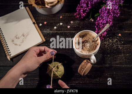Decorating macaroons with canvas thread. Tie bows on the macaroons Stock Photo