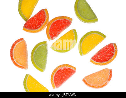 Falling marmalade sweets in the form of citrus fruits isolated on white background. Stock Photo