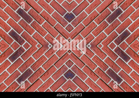 Wall of red brick. Bricks lined in the shape of a pattern and converge in the center Stock Photo