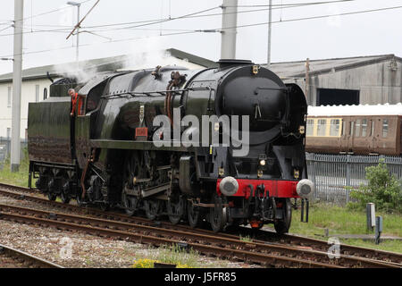 Southern Region Merchant Navy class steam locomotive British India Line carrying the nameplate Bodmin being tested on a line by Carnforth station. Stock Photo