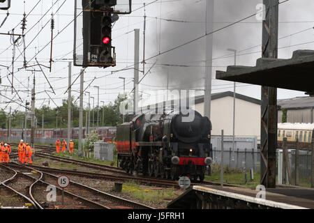 Southern Region Merchant Navy class steam locomotive British India Line carrying the nameplate Bodmin being tested on a line by Carnforth station. Stock Photo