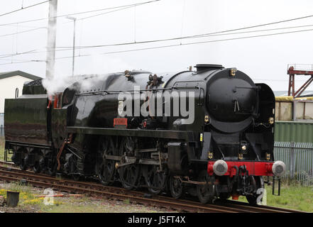 Southern Region Merchant Navy class steam locomotive British India Line carrying the nameplate Bodmin being tested on a line by Carnforth station. Stock Photo