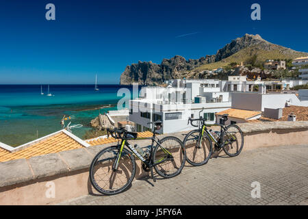 Two road bikes at the beautiful fishing village of Cala Sant Vicenc, , near Pollensa, Mallorca, Majorca, Balearic Islands, Spain Stock Photo