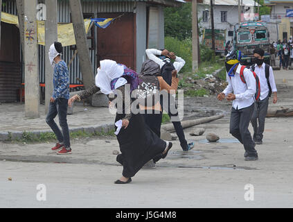 Kashmir. 17th May, 2017. Female students throw stones during clashes in Srinagar the summer capital of Indian controlled Kashmir on May 17, 2017.Indian police used teargas shells, chili smoke and stun grenades to disperse them. The agitating student were protesting against the Indian police raid in last month in April in Degree college Pulwama which left more than fifty students injured in Police action. Credit: Faisal Khan/Pacific Press/Alamy Live News Stock Photo