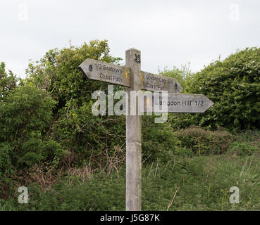 Direction signs on the south west coast path near Golden Cap, Dorset. Stock Photo