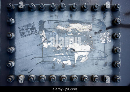 Bolts on grunge textured metal background Stock Photo