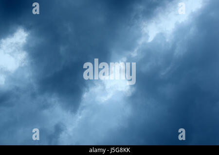 Grey and white clouds. Clouds are a visible mass of condensed water vapor floating in the atmosphere, typically high above the ground. Stock Photo