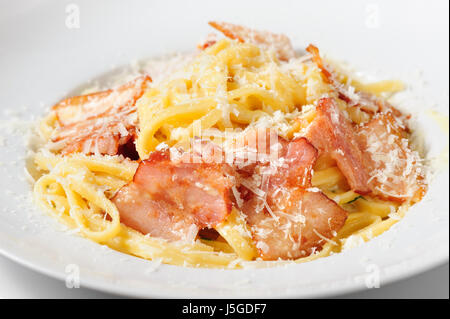 top view tagliatelli carbanara italian cuisine on plate rustic kitchen table background Stock Photo