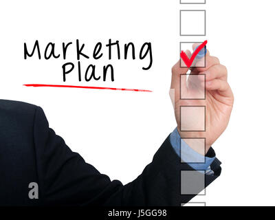 Businessman hand writing Marketing Plan and check listing task. Isolated on white background. Stock photo Stock Photo