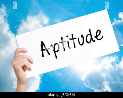 Aptitude Sign on white paper. Man Hand Holding Paper with text. Isolated on sky background.  Business concept. Stock Photo Stock Photo