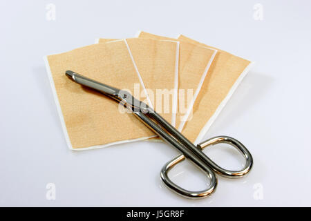 plaster wound injury scissors scissor means agent medicine drug remedy Stock Photo